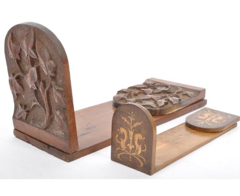 A 19th century Victorian book trough folding slide with carved ends in oak wood together with a marquetry inlaid book trough 