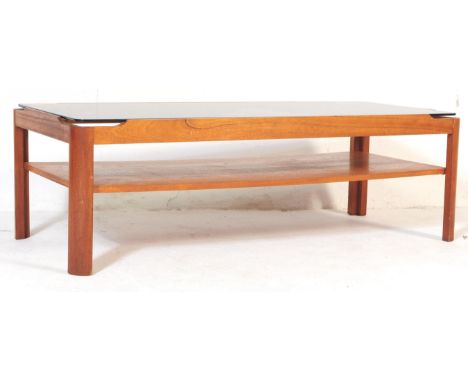 A retro vintage mid 20th century teak and glass Myer coffee table. Of rectangular form with smoked drop in glass top with dro