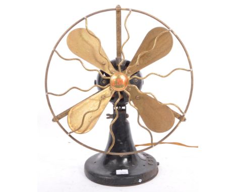 A retro vintage 20th century circa 1930s EMI industrial desk top table fan having a brass fan over a black metal base. Type L