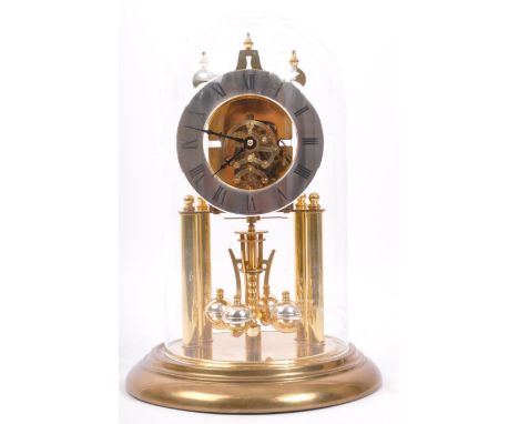 A vintage, late 20th century German anniversary / Mantel clock raised on a circular plinth base. Comes with a glass dome cove