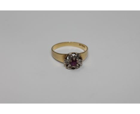 An 18ct gold ruby and diamond cluster ring, size K/L, 2.6g.