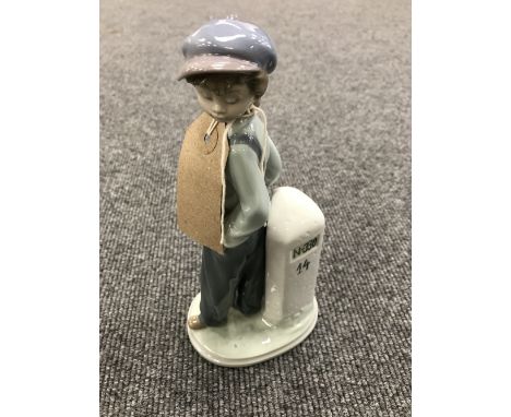 A Lladro figure - number 5400 boy wit nap sack 