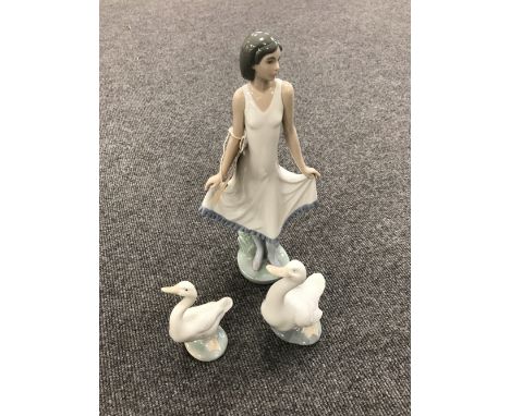 A Nao figure - girl in dress and a Nao swan 