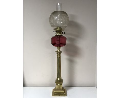 An antique brass Corinthian column oil lamp with chimney and shade 