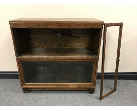 An oak twin section Globe Wernicke stacking bookcase (top shelf lacking glass)