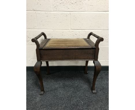 An early twentieth century oversized storage piano stool together with a plant stand 