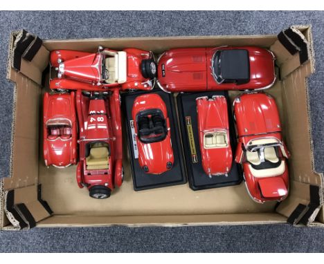 A box containing seven die cast Burago large scale die cast vehicles  
