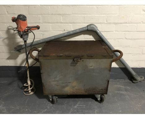A metal storage chest on wheels, together with a plaster mixer and a metal handrail 
