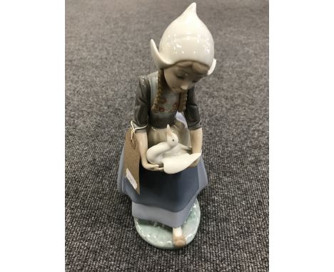 A Lladro figure - girl carrying a goose 