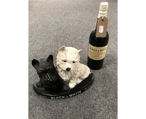 Two mid twentieth century black and white scotch whiskey advertisements, a cigarette holder in the form of a bottle, together