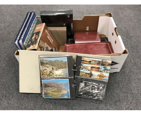 A box of nine post card albums and a scrap album of cigarette pack advertisements 