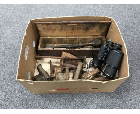 A box containing a pair of Tasco binoculars, vintage flat irons, a small pine box containing chisels, etc