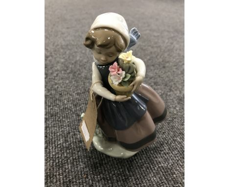 A Lladro figure - girl with flowers 