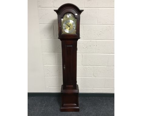 A Tempus Fugit granddaughter clock with a brass dial 