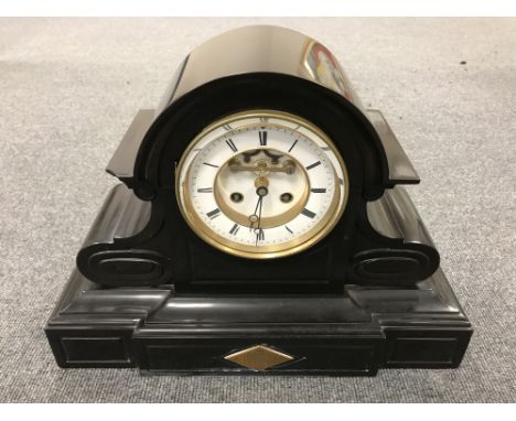 A late nineteenth century slate mantel clock, with enamelled dial, pendulum and key 