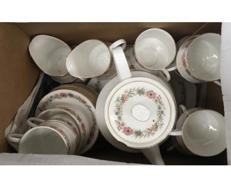 A Paragon Belinda tea service with two serving plates, 12 side plates, 11 saucers, two milk jugs, sugar bowl, 10 cups, one po