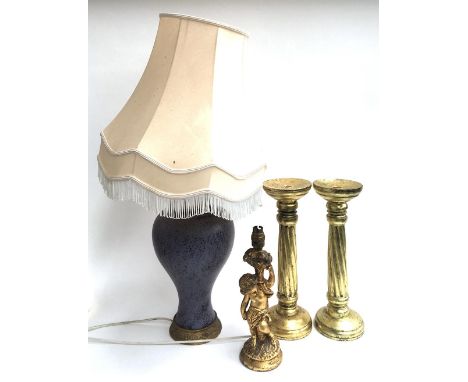 A pair of spirally turned gilt candlesticks, 39cmH, together with a giltwood table lamp in the form of a cherub, and a purple