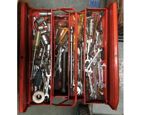 A metal toolbox containing spanners and sockets etc 