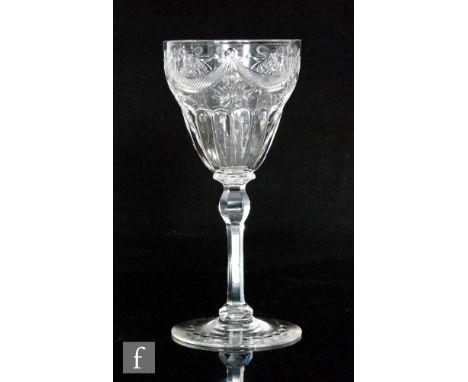 An early 20th Century Thomas Webb &amp; Sons clear crystal wine glass with a fluted ogee bowl with polished intaglio ribbon t