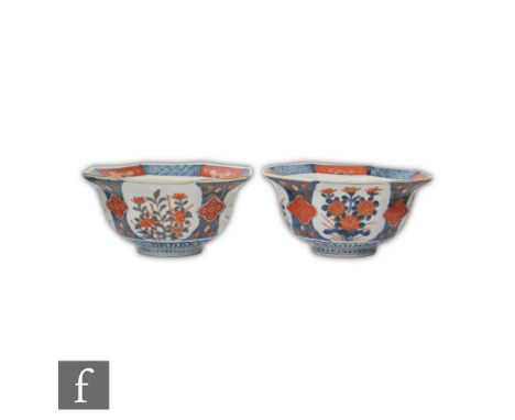 A pair of 19th Century Chinese Imari bowls, each rising from a high footring, the circular bowl with an everted rim, decorate