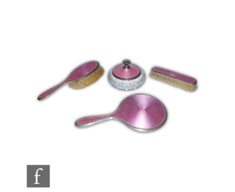 A hallmarked silver and pink enamel decorated three piece brush set, mirror and two brushes, with a conforming powder jar and