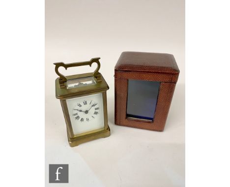 A late 19th to early 20th Century brass and bevelled glass panelled carriage clock, the movement stamped Made in France, heig