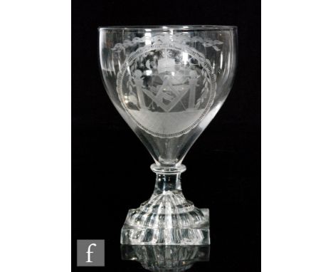 An early 19th Century glass rummer, circa 1810, the ogee bowl engraved with Masonic emblems above a capstan stem, raised to a