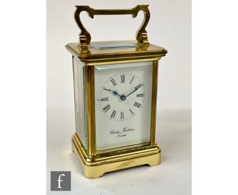 A 20th Century brass carriage clock, Roman numerals to a white enamelled dial above Charles Frodsham, London, height 12cm. 