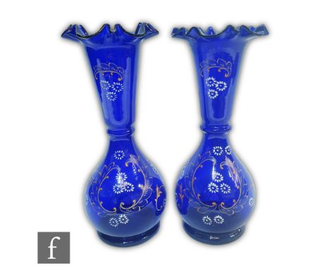 A pair of late 19th Century French blue glass vases of footed globe and flared shaft form with a frilled rim edge, the bodies