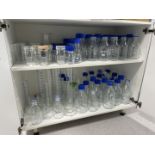 Qty of various glassware to cupboard including bottles, measuring funnels etc.