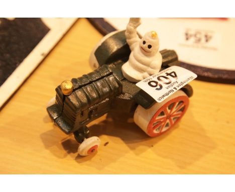 Cast iron Michelin Man in tractor figurine, H: 8 cm. P&amp;P Group 2 (£18+VAT for the first lot and £3+VAT for subsequent lot