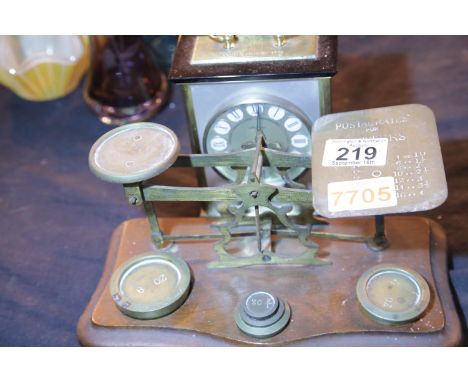 Vintage brass and mahogany postal scales with graduated weights, and a Seth Thomas mantel clock. P&amp;P Group 2 (£18+VAT for