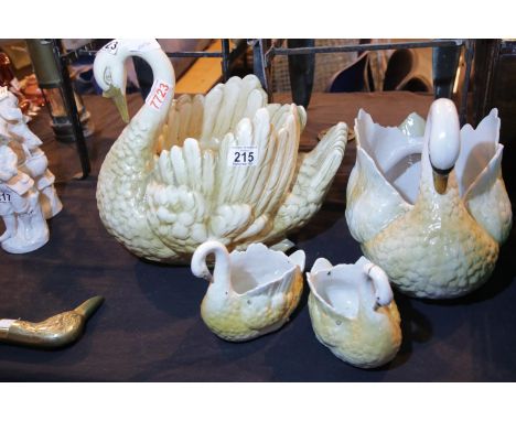 Four graduated ceramic Swans, one with repaired neck, largest 27 cm. Not available for in-house P&amp;P. 