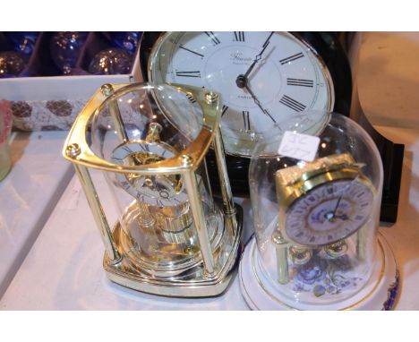Collection of three quartz clocks, piano black napoleon mantel clock, Skeleton clock with moon phase and platform escapement 