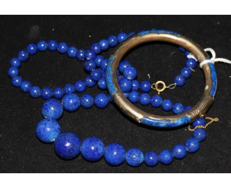 A lapis lazuli necklace and bangle.