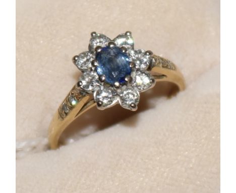 An 18ct gold, sapphire and diamond cluster ring with diamond-set shoulders, size L.
