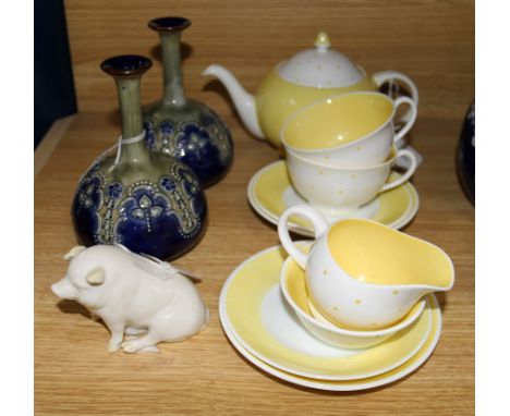 A pair of Royal Doulton Art Nouveau narrow neck bottle vases, a Belleek pig and a Susie Cooper yellow and white polka dot tet