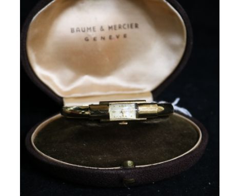 A lady's 14ct gold Baume & Mercier manual wind open bangle wrist watch, in original box.