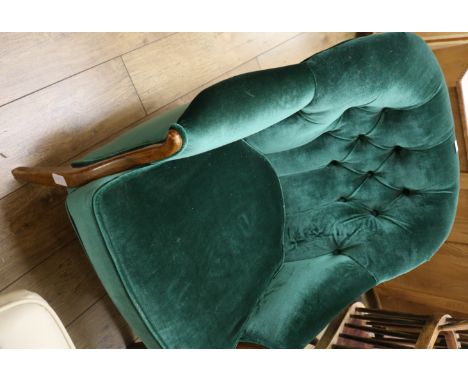 A dark green button back armchair