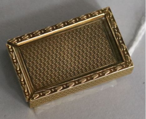 A 1960's 9ct gold engine-turned rectangular patch box, with harebell and bead edging and sliding cover, 15.7gms, 32mm.