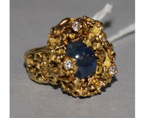 A modernist 18ct textured gold, cabochon sapphire and diamond dress ring, size E.