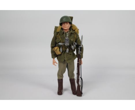 Palitoy, Action Man - A Palitoy dark brown painted head Action Man figure in Combat Soldier outfit. The hard hand figure, is 