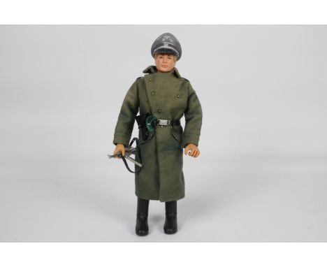 Palitoy, Action Man - A Palitoy Action Man figure in German Camp Kommandant outfit. The blone flock haired figure with grippi