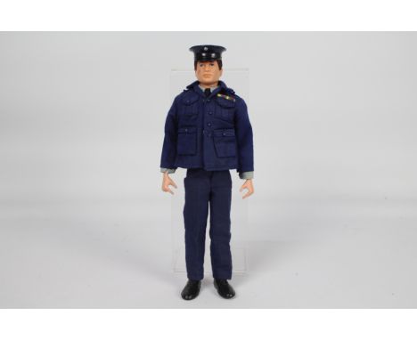 Palitoy, Action Man - A Palitoy Action Man dark brown flock haired figure in RAF Officer outfit. The figure with hard hands, 