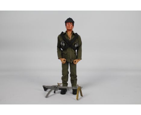 Palitoy, Action Man - A Palitoy Eagle-Eye Action Man figure in Commando outfit. The dark brown flock haired figure with gripp