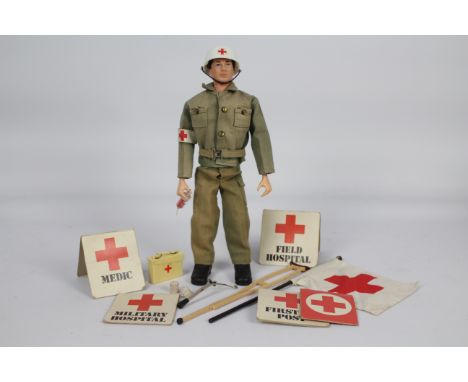 Palitoy, Action Man - A Palitoy Action Man figure in Medic outfit. The dark brown flock haired figure with hard hands is mark
