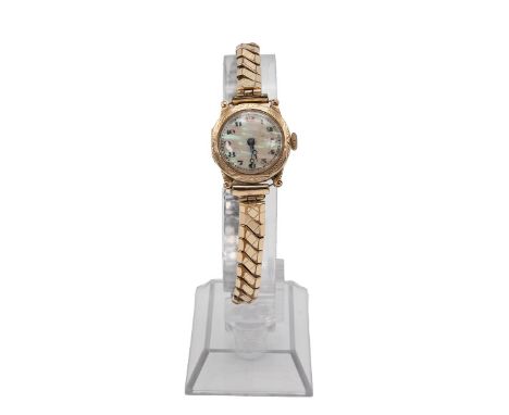 9ct gold ladies watch. Manual wind, 22mm case, mother of pearl dial, Arabic hour markers. With a gold plated elesticated stra