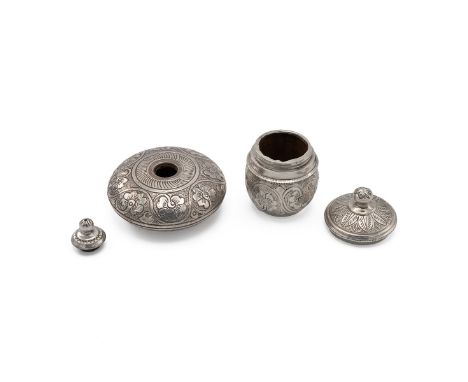 Two Middle Eastern silver condiment jars, the corked lined jars each decorated with trailing flowers and plants, and having d