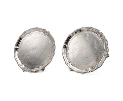 A pair of 18th Century Irish silver salvers with gadroon fluted border, with further decoration of garlands of flowers, raise