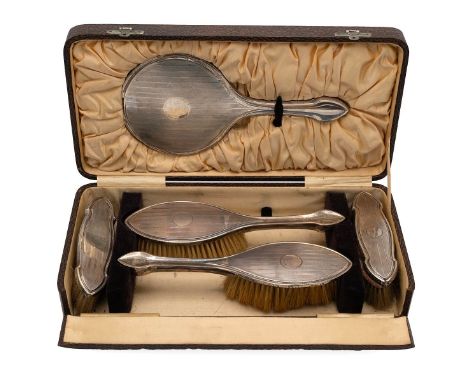 A silver-backed engine turned five-piece dressing table set, each with a vacant cartouche, cased, Birmingham 1922, Davis, Mos